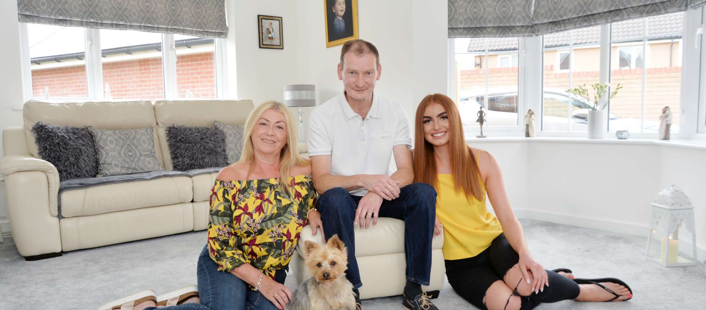 Family on sofa with dog playing